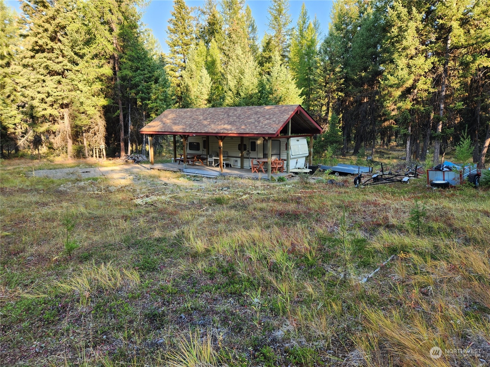 5 Prior Loop Road Oroville, WA 98844 - Photo 29 of 34 a view of a house with a yard and sitting area