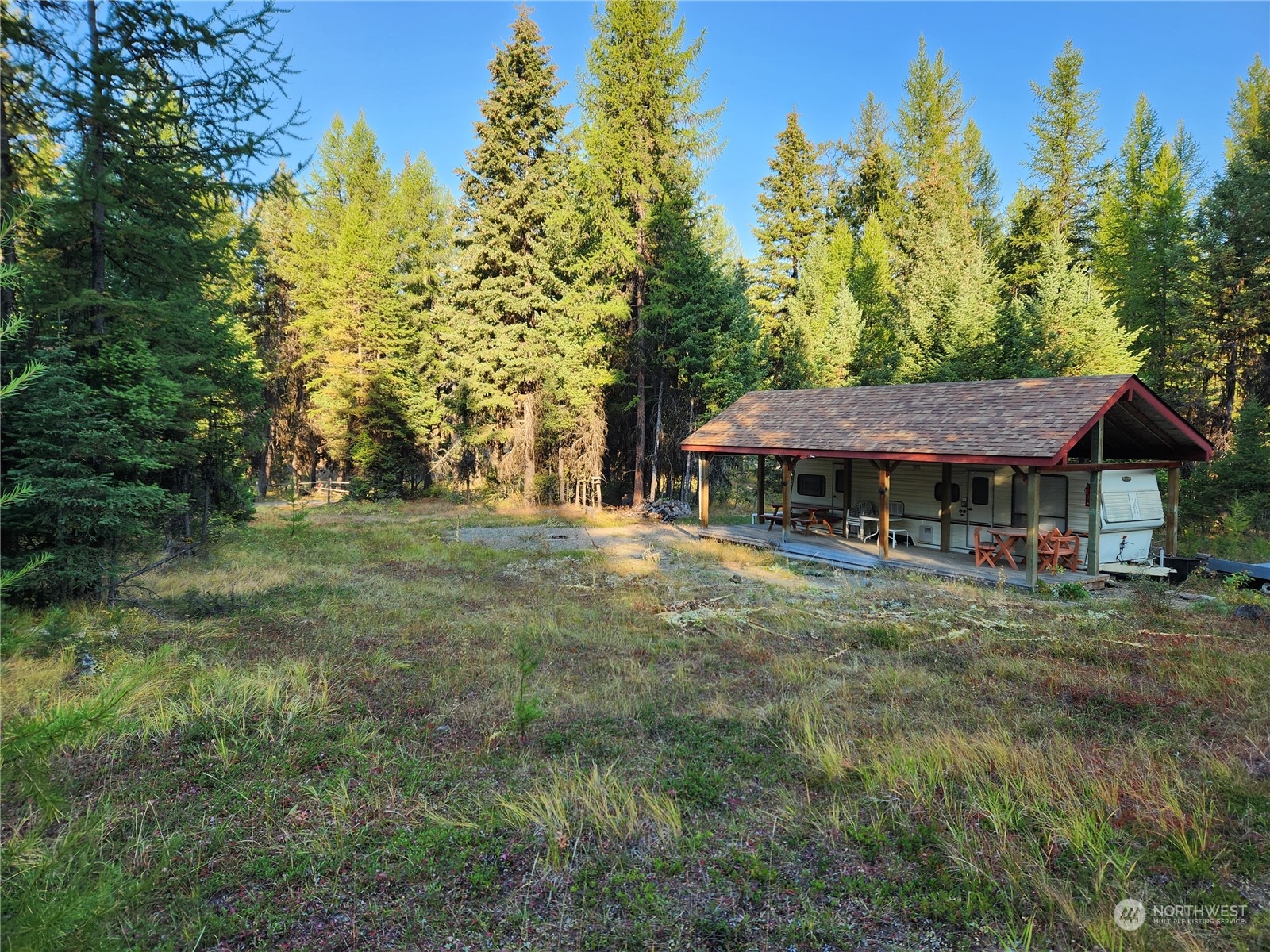 5 Prior Loop Road Oroville, WA 98844 - Photo 30 of 34 a view of a big house with a big yard and large trees