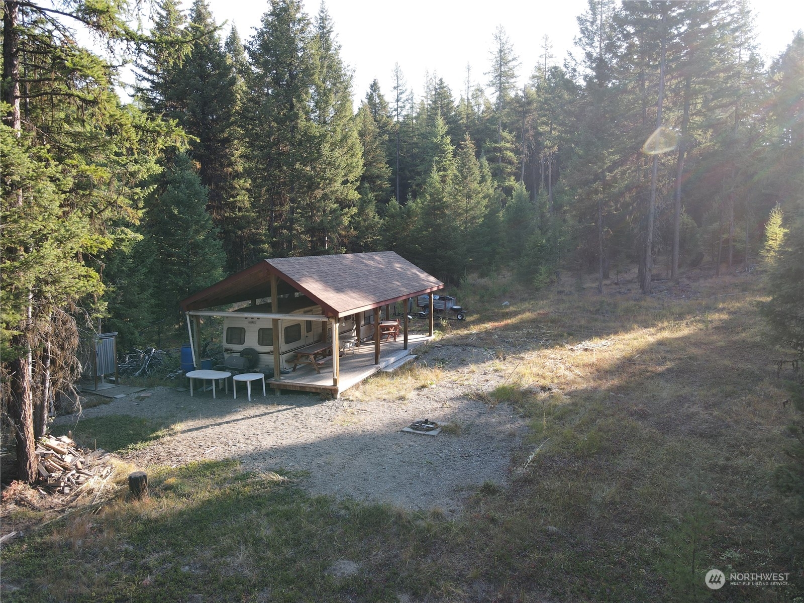 5 Prior Loop Road Oroville, WA 98844 - Photo 4 of 34 a view of a house with a yard in a forest