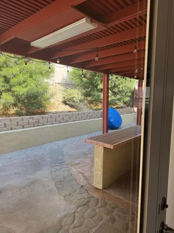 a view of a porch with furniture and a yard