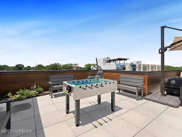 a view of a terrace with couches and wooden floor