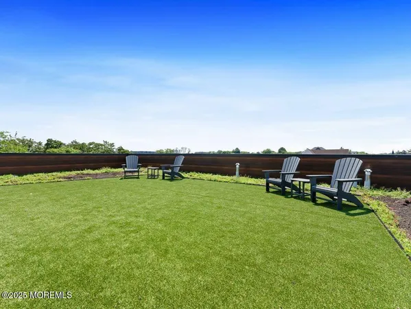 a view of a garden with lawn chairs