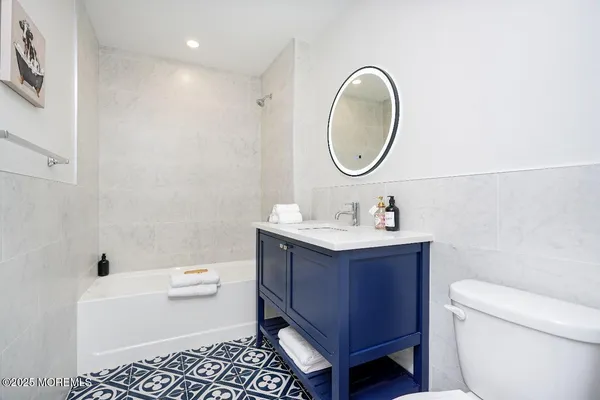 a bathroom with a sink toilet and a mirror