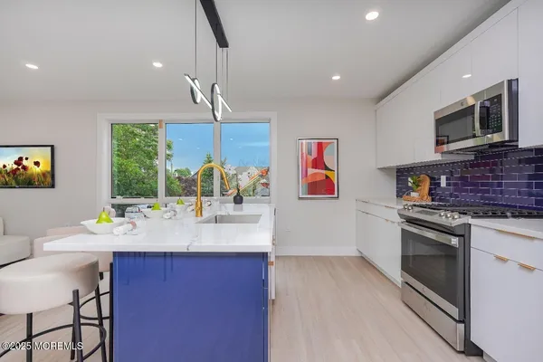 a kitchen with a sink cabinets and window