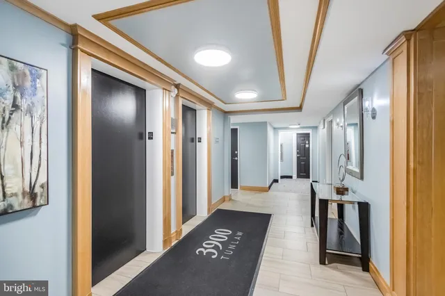 a hallway with dining area and glass doors