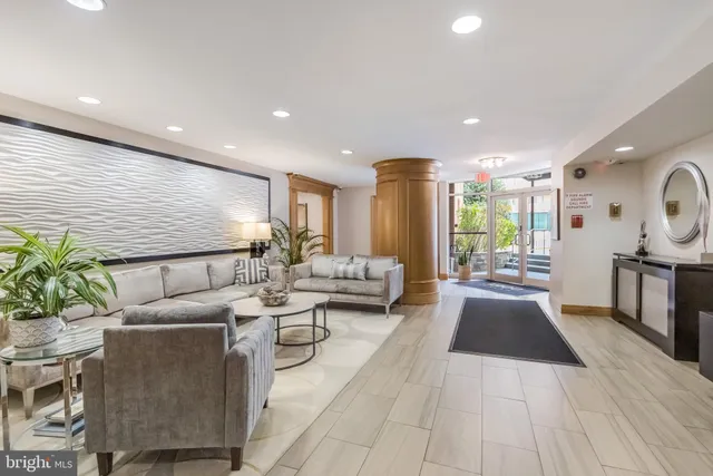 a living room with furniture and a large window