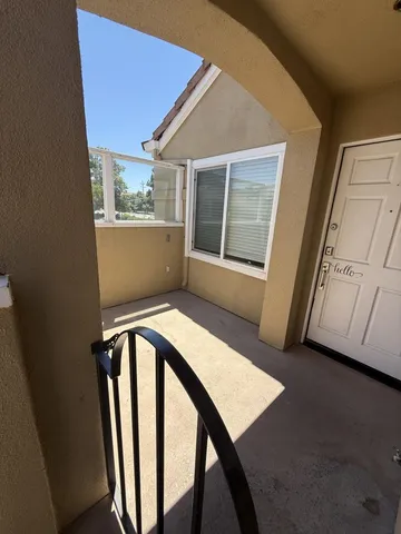 a view of a balcony with wooden floor and furniture