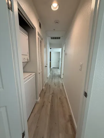 a storage room with wooden floor and white walls