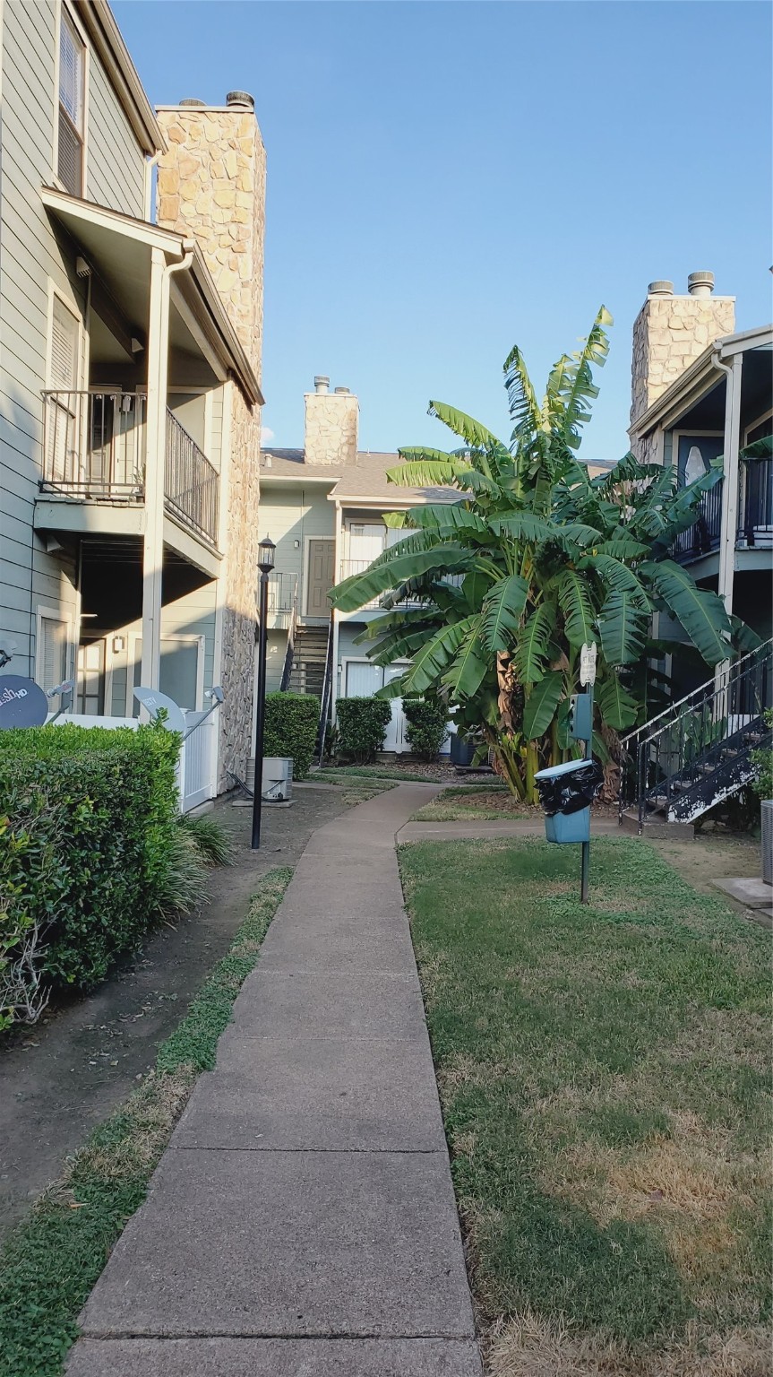 3768 Tanglewilde Street, Unit J5 Houston, TX 77063 - Photo 20 of 24 a view of a street with brick building in front of it