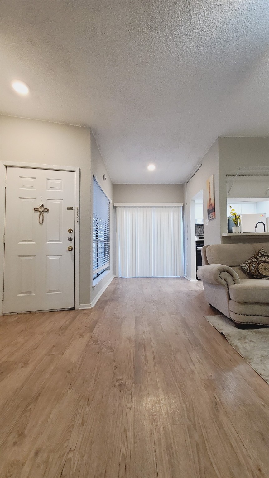 3768 Tanglewilde Street, Unit J5 Houston, TX 77063 - Photo 4 of 24 a view of a livingroom with furniture and cabinet