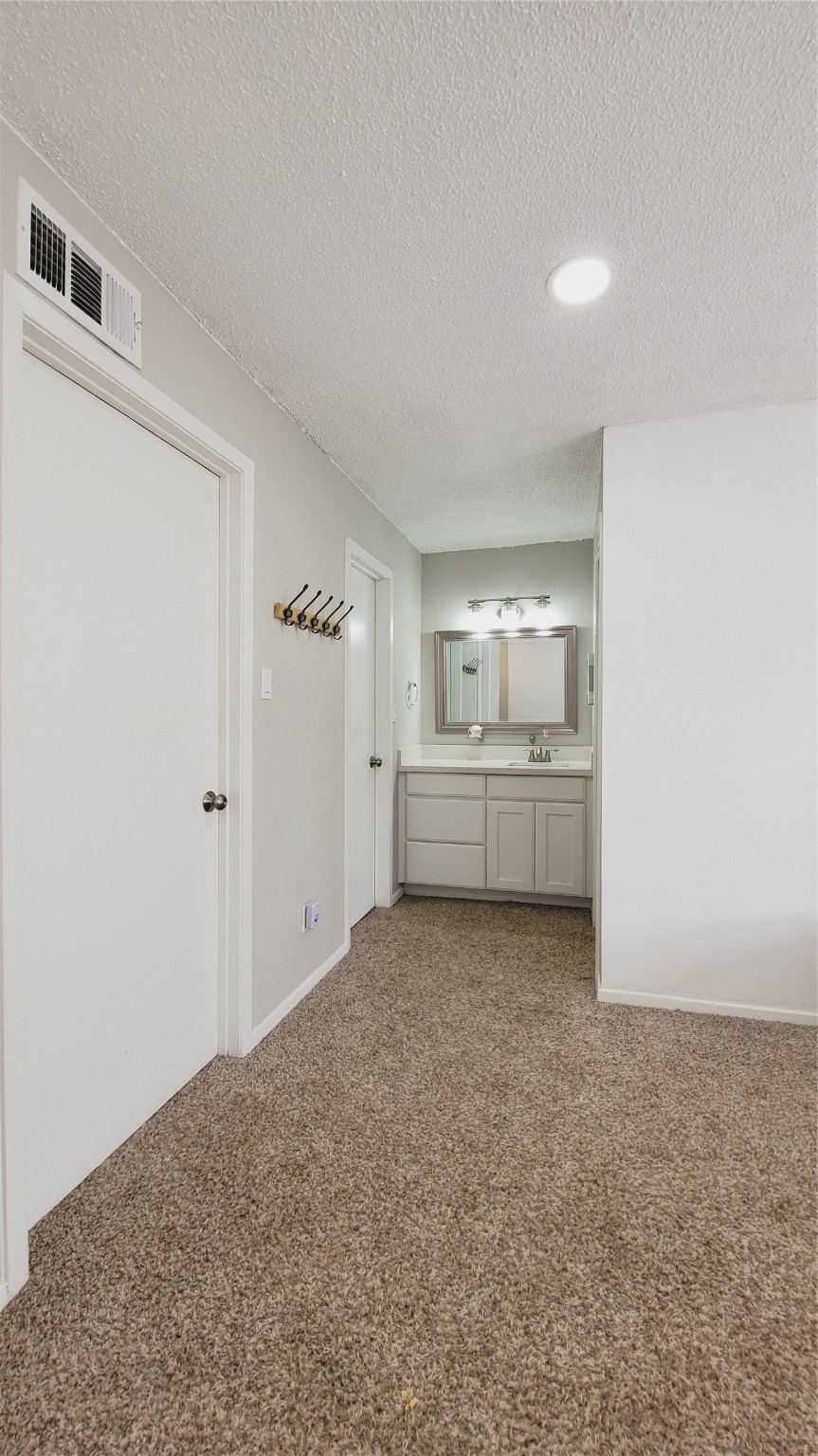 3768 Tanglewilde Street, Unit J5 Houston, TX 77063 - Photo 8 of 24 a view of a room with closet and cabinet