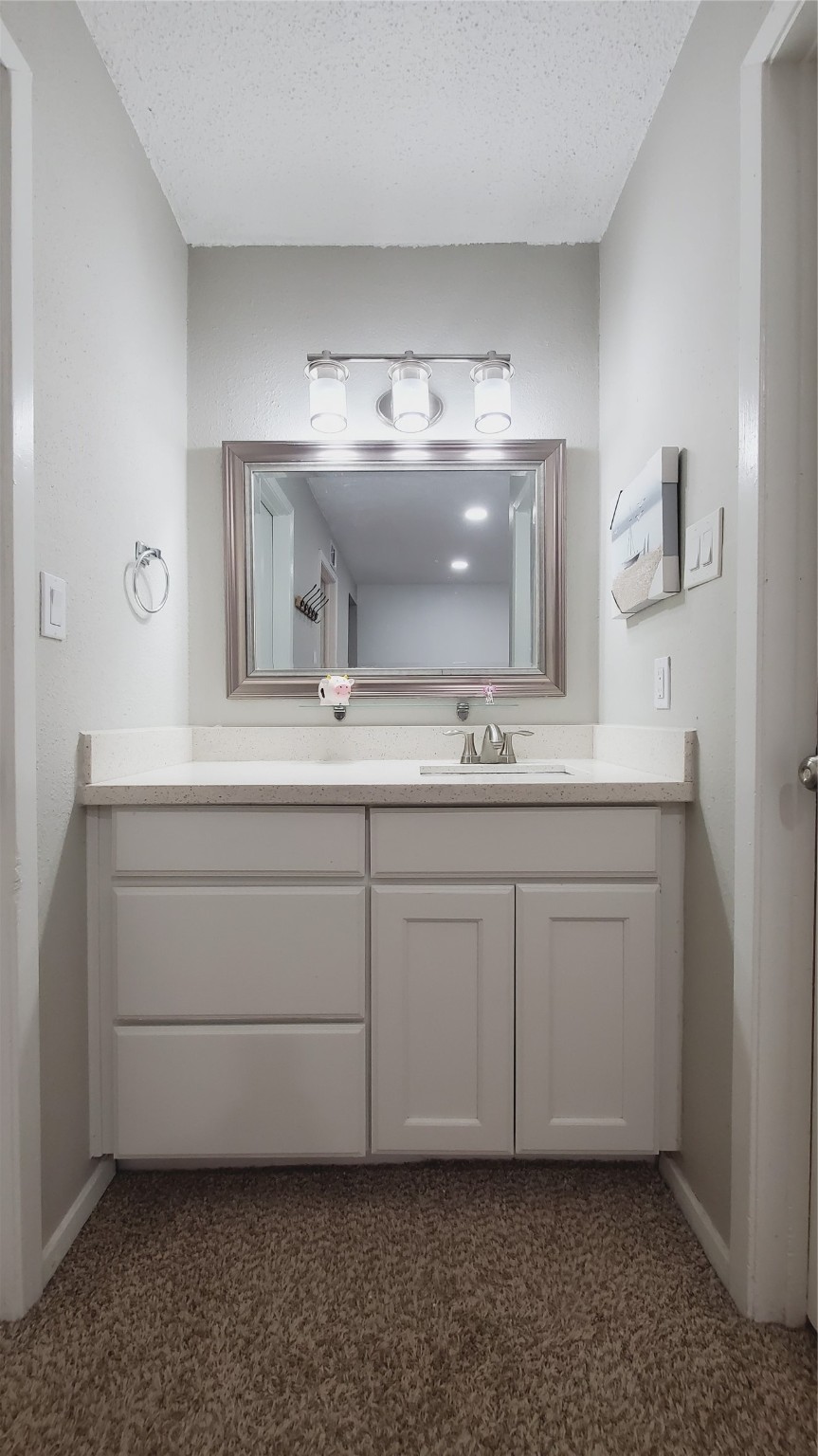 3768 Tanglewilde Street, Unit J5 Houston, TX 77063 - Photo 9 of 24 a bathroom with a sink and a mirror