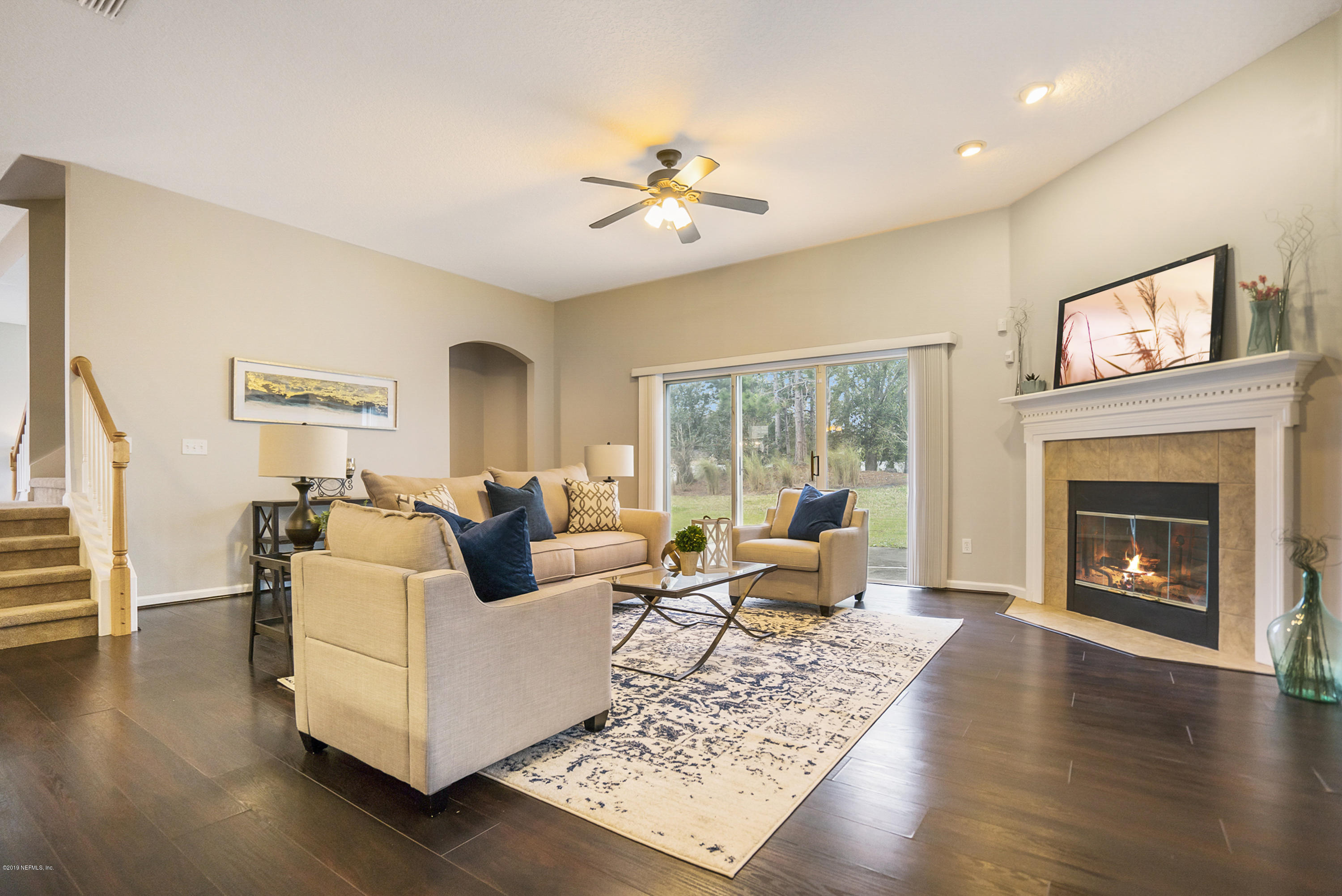 1409 Riva Del Garda Way St. Augustine, FL 32092 - Photo 11 of 41 a living room with furniture and a fireplace
