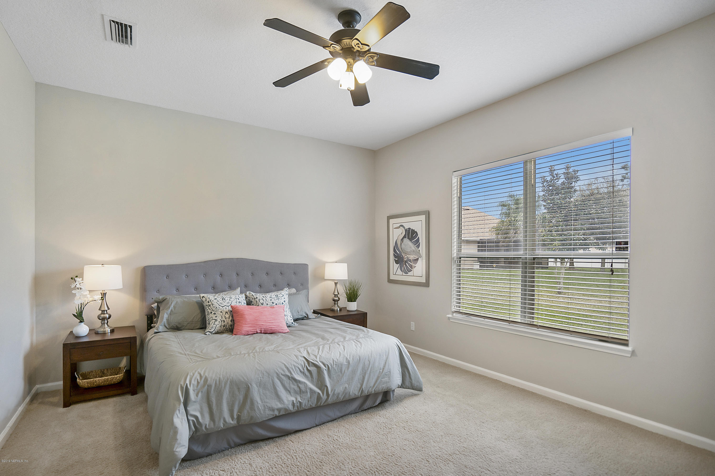 1409 Riva Del Garda Way St. Augustine, FL 32092 - Photo 13 of 41 a bedroom with a bed and a window