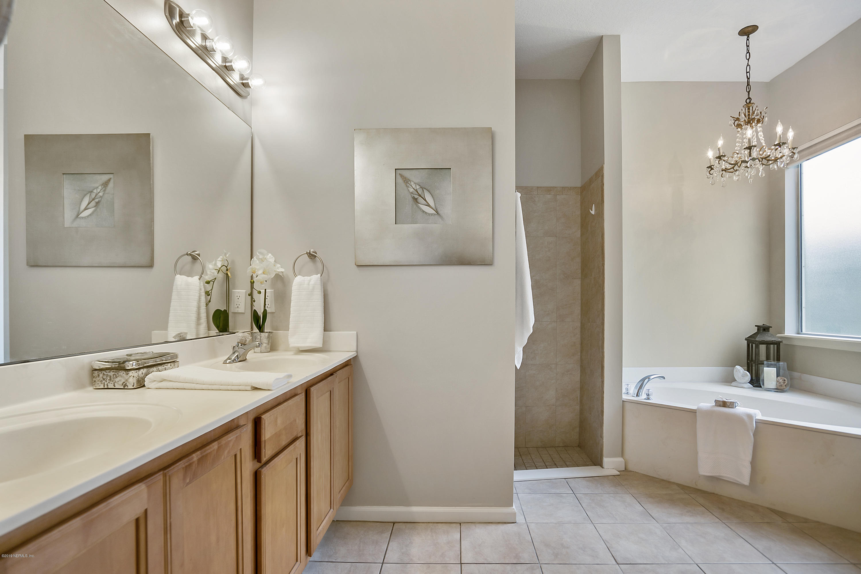 1409 Riva Del Garda Way St. Augustine, FL 32092 - Photo 14 of 41 a bathroom with a sink a vanity and a mirror