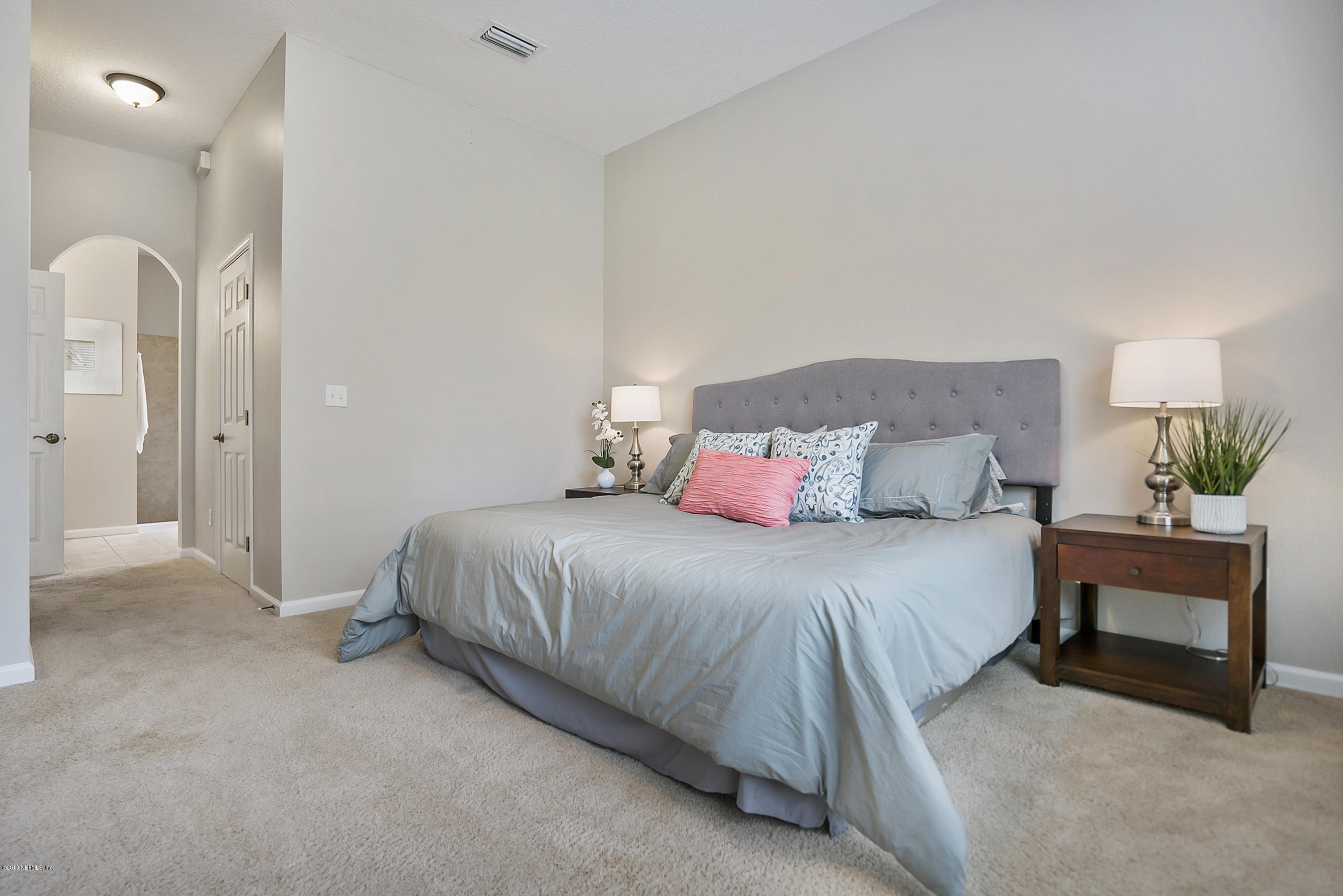 1409 Riva Del Garda Way St. Augustine, FL 32092 - Photo 16 of 41 a bedroom with a bed and a couch