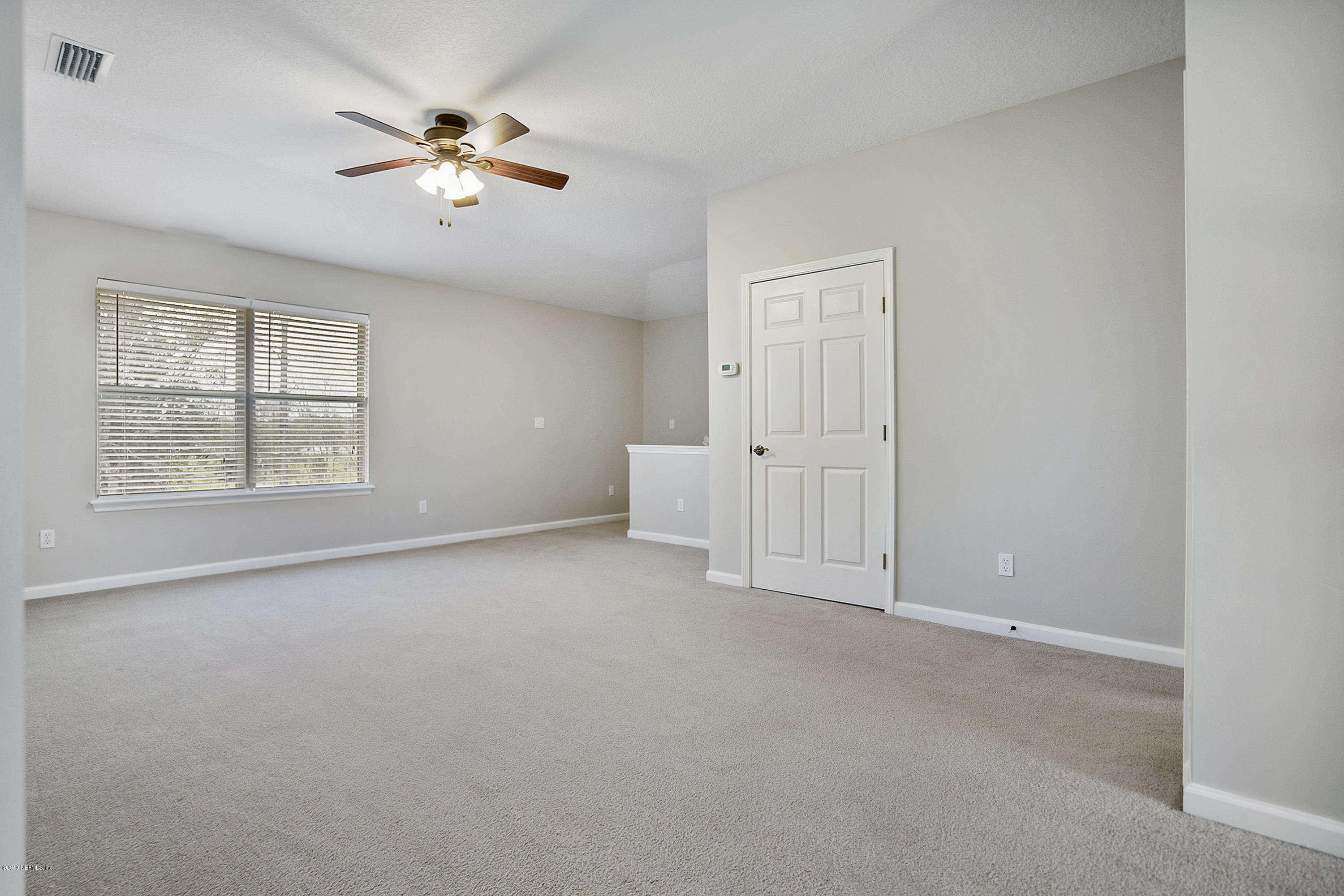 1409 Riva Del Garda Way St. Augustine, FL 32092 - Photo 19 of 41 an empty room with windows and chandelier fan