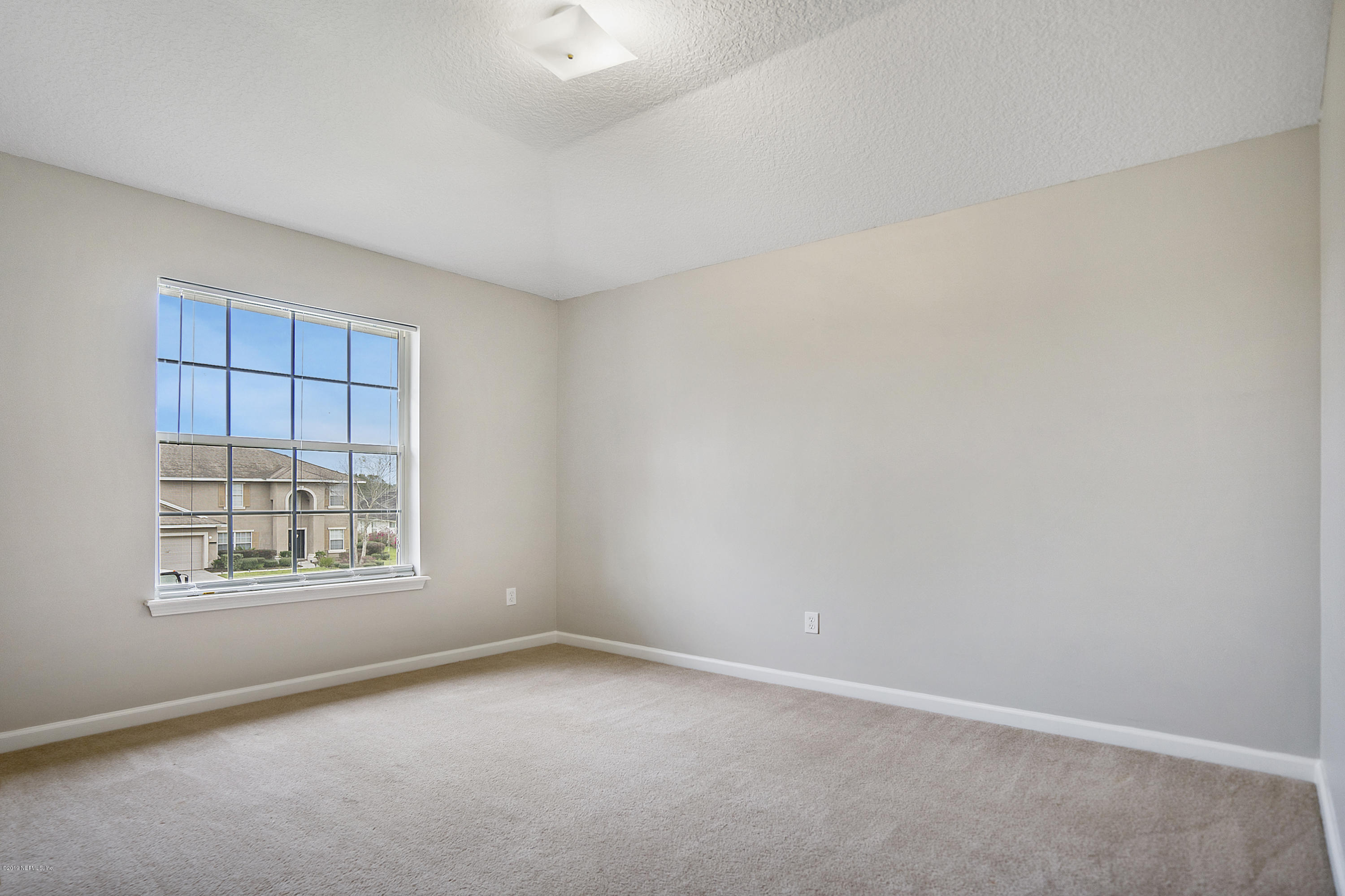 1409 Riva Del Garda Way St. Augustine, FL 32092 - Photo 22 of 41 an empty room with a window