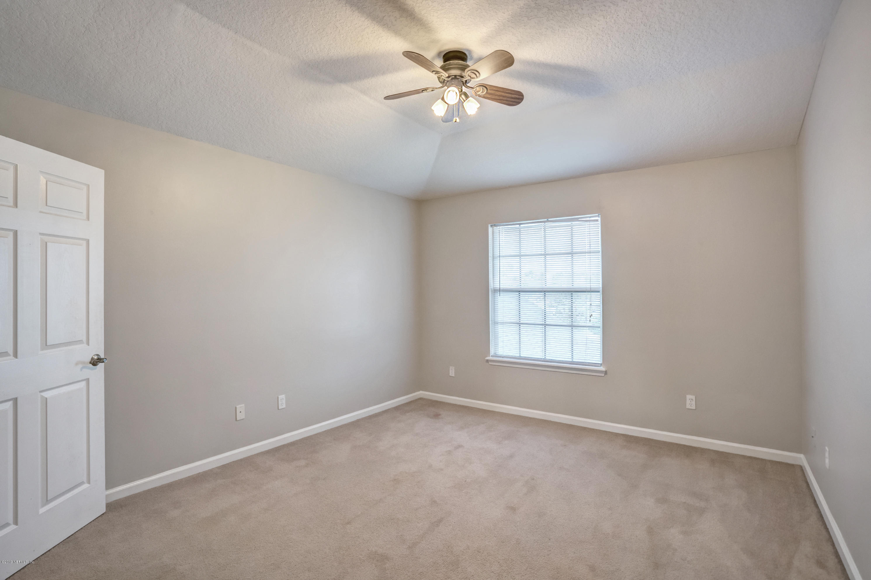 1409 Riva Del Garda Way St. Augustine, FL 32092 - Photo 23 of 41 an empty room with a window and a fan