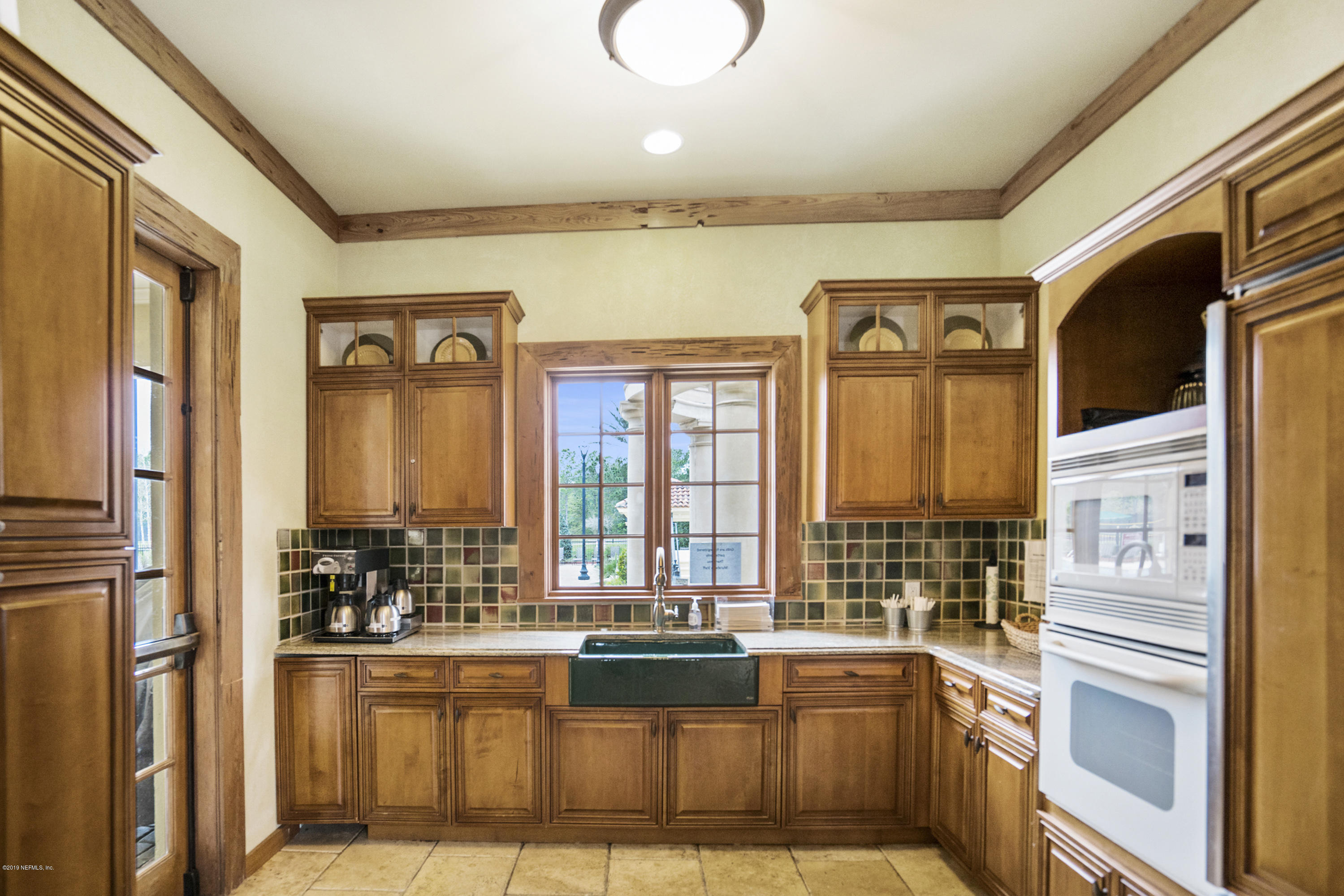 1409 Riva Del Garda Way St. Augustine, FL 32092 - Photo 34 of 41 a view of open kitchen with granite countertop a refrigerator and a sink