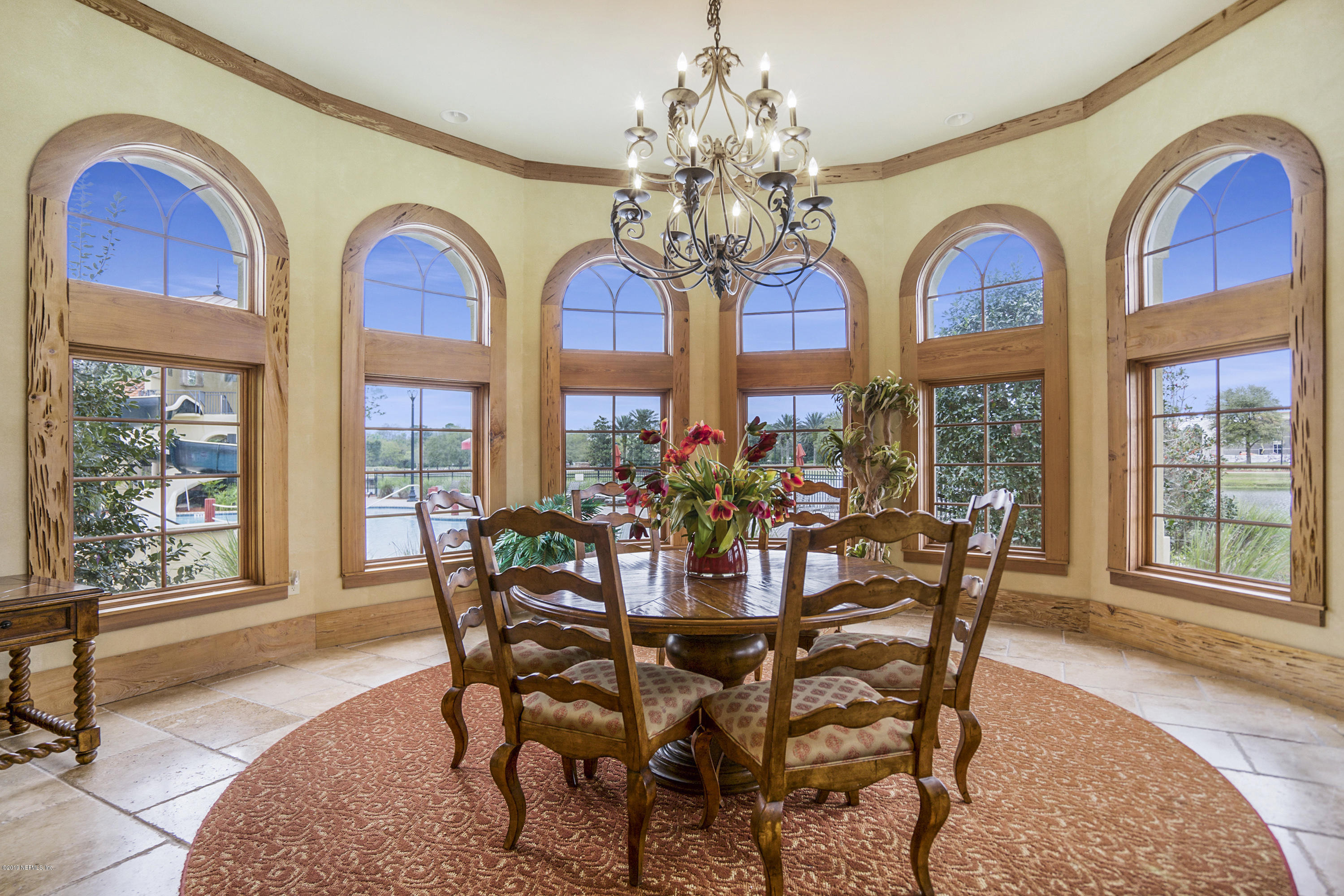 1409 Riva Del Garda Way St. Augustine, FL 32092 - Photo 35 of 41 a view of a dining room with furniture a chandelier and wooden floor