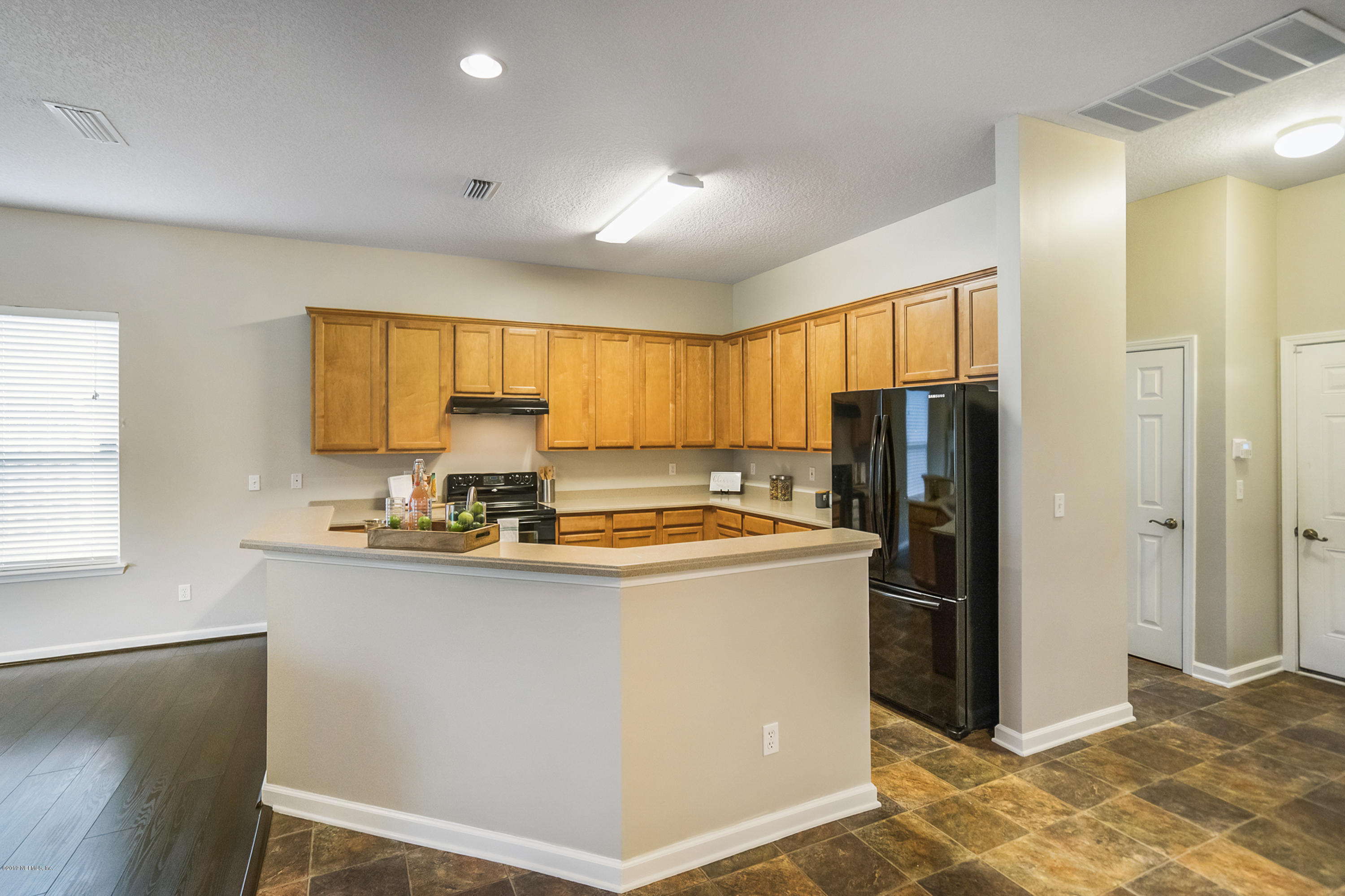 1409 Riva Del Garda Way St. Augustine, FL 32092 - Photo 9 of 41 a view of a kitchen with a window a refrigerator and a sink