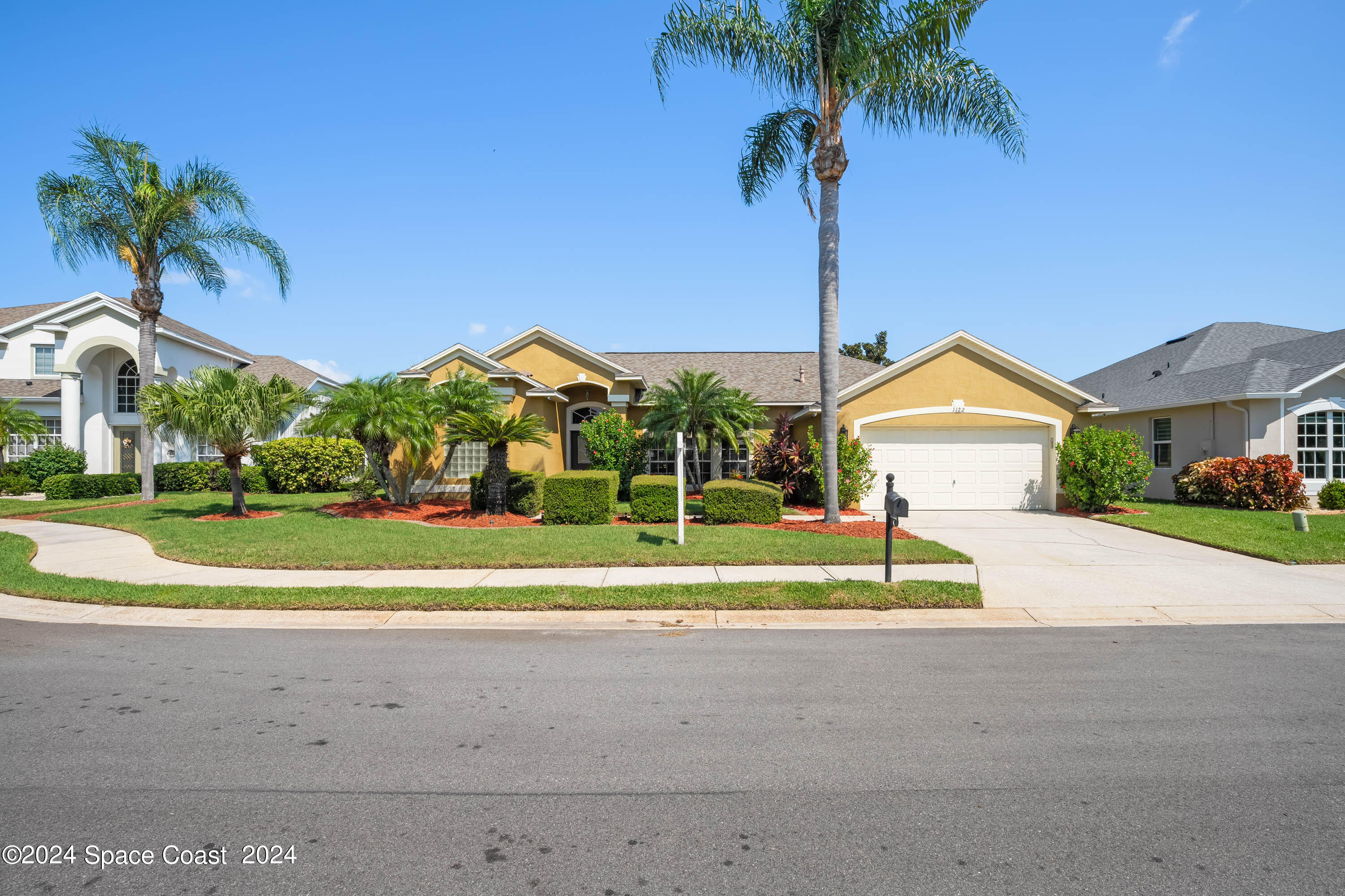 1122 Jan's Place Melbourne, FL 32940 - Photo 1 of 42 a house with a garden and a yard