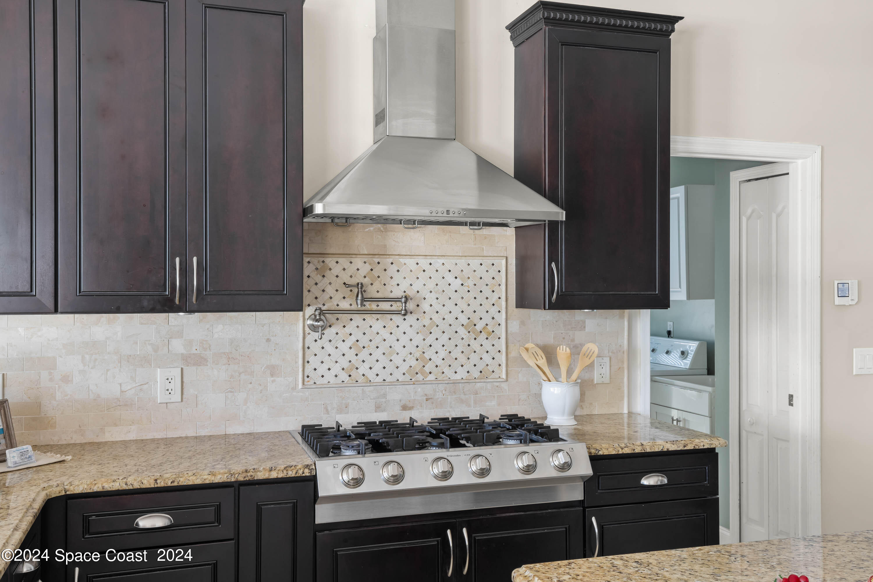 1122 Jan's Place Melbourne, FL 32940 - Photo 12 of 42 a kitchen with a sink stove and cabinets
