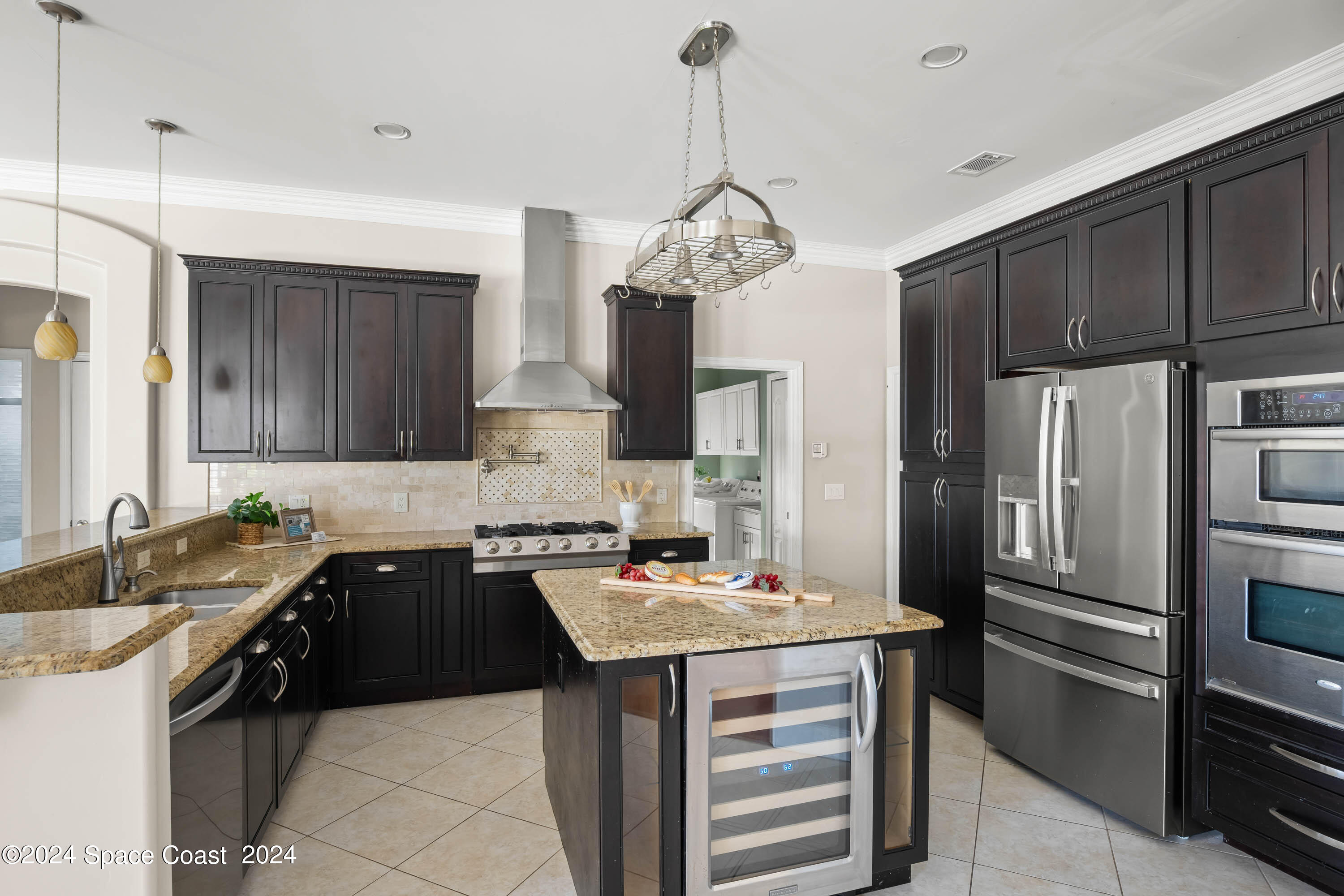 1122 Jan's Place Melbourne, FL 32940 - Photo 13 of 42 a kitchen with stainless steel appliances granite countertop a sink stove and refrigerator