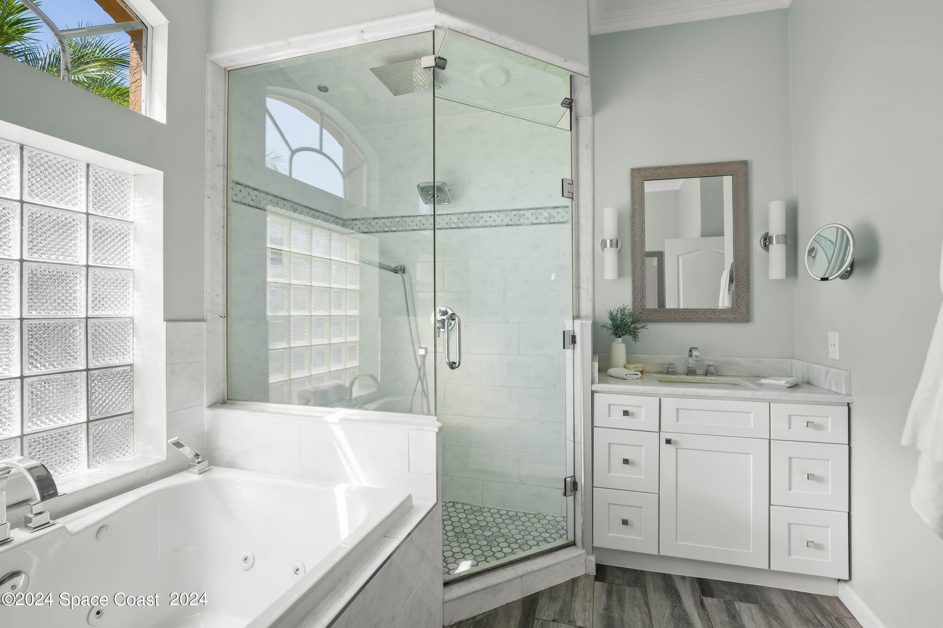 1122 Jan's Place Melbourne, FL 32940 - Photo 17 of 42 a bathroom with a tub sink and a mirror