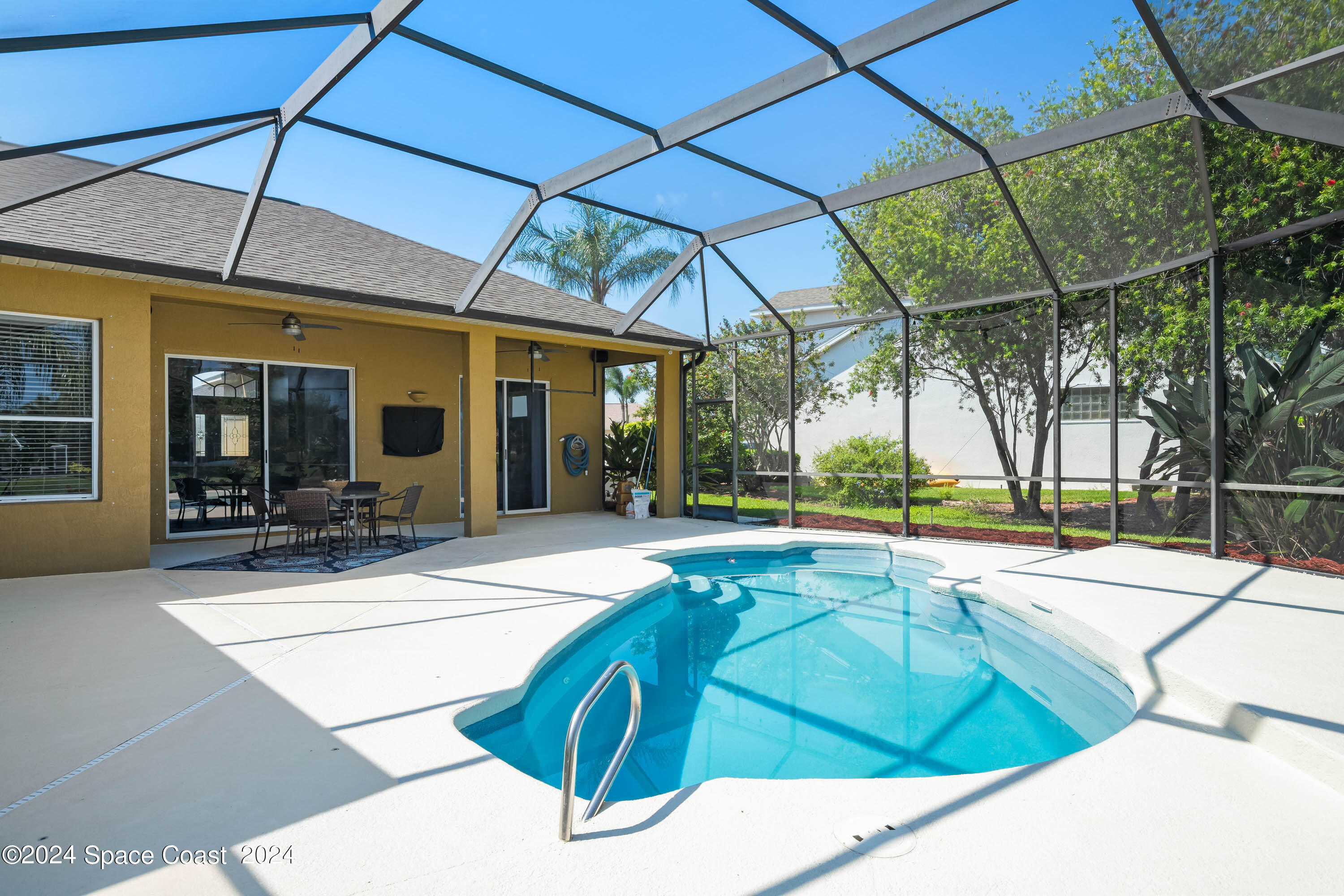 1122 Jan's Place Melbourne, FL 32940 - Photo 27 of 42 a swimming pool with outdoor seating and yard