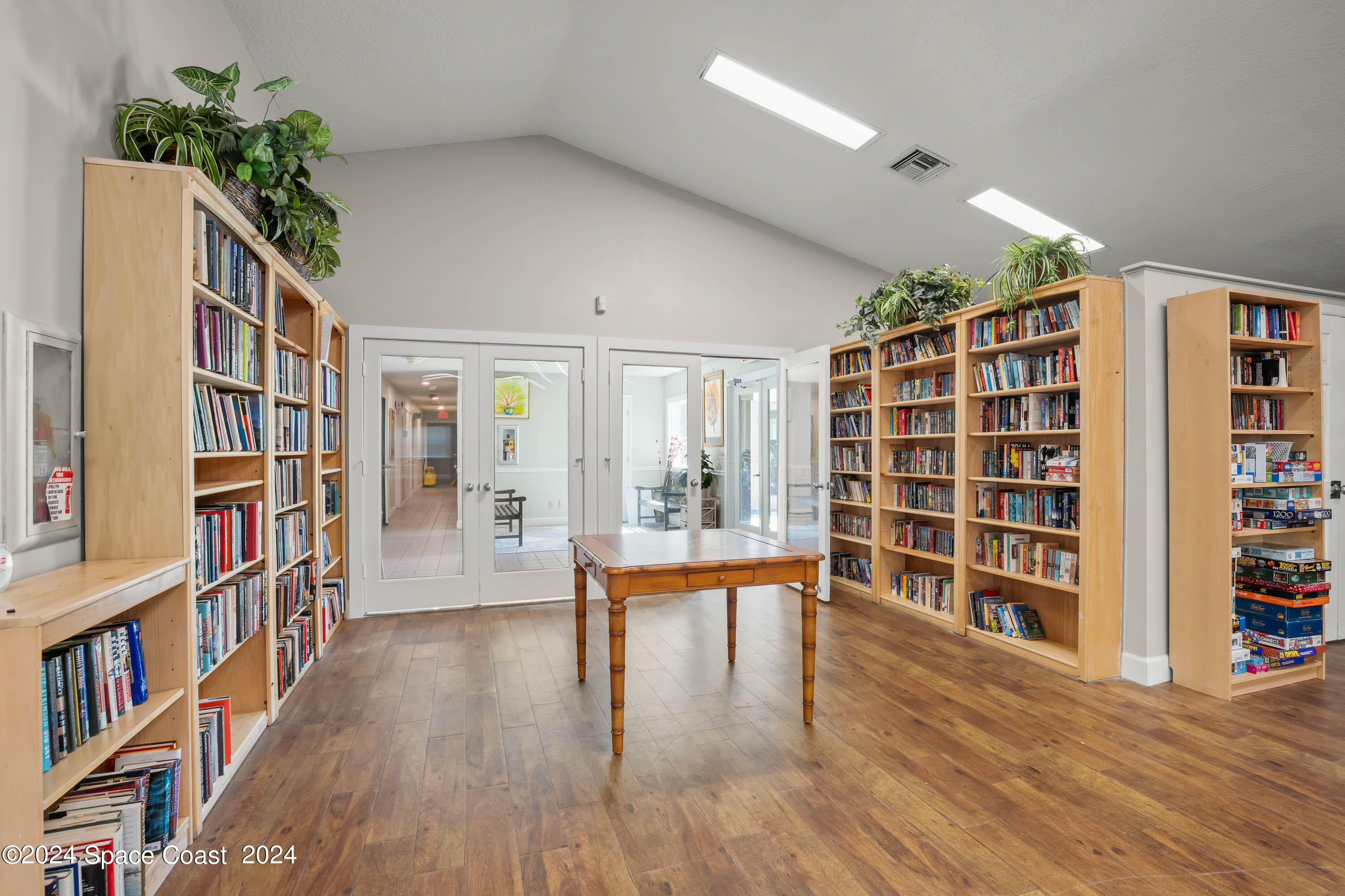 1122 Jan's Place Melbourne, FL 32940 - Photo 38 of 42 a hallway with wooden floor and book shelf