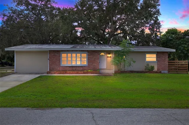 a front view of house with yard and outdoor seating