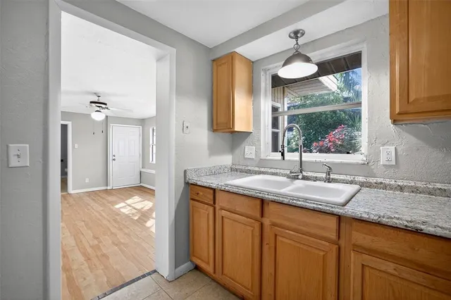 a kitchen with a sink and a wooden cabinets