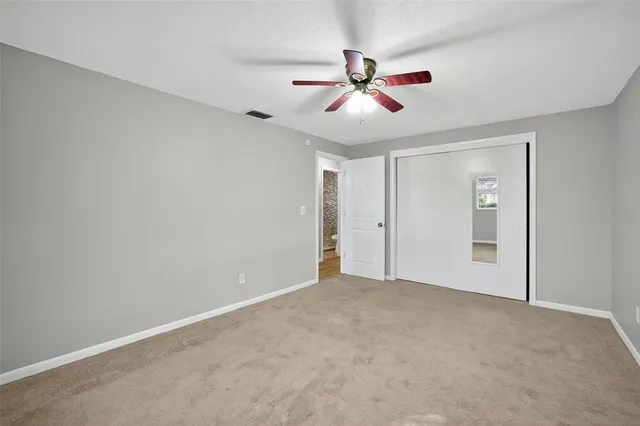 a view of an empty room with a fan