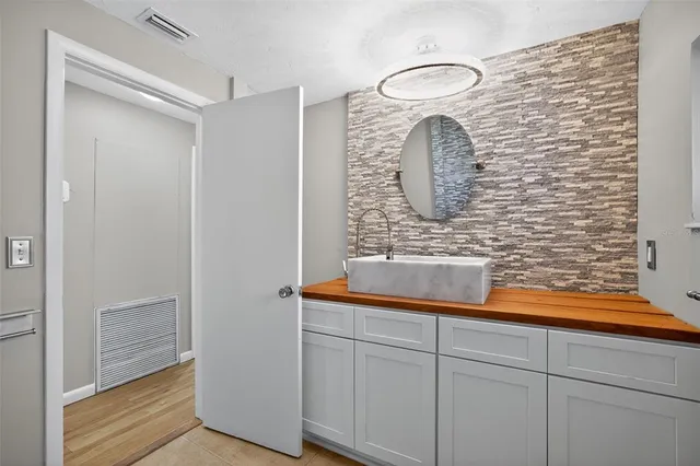 a bathroom with a sink and a mirror