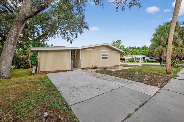 a view of backyard of house with green space