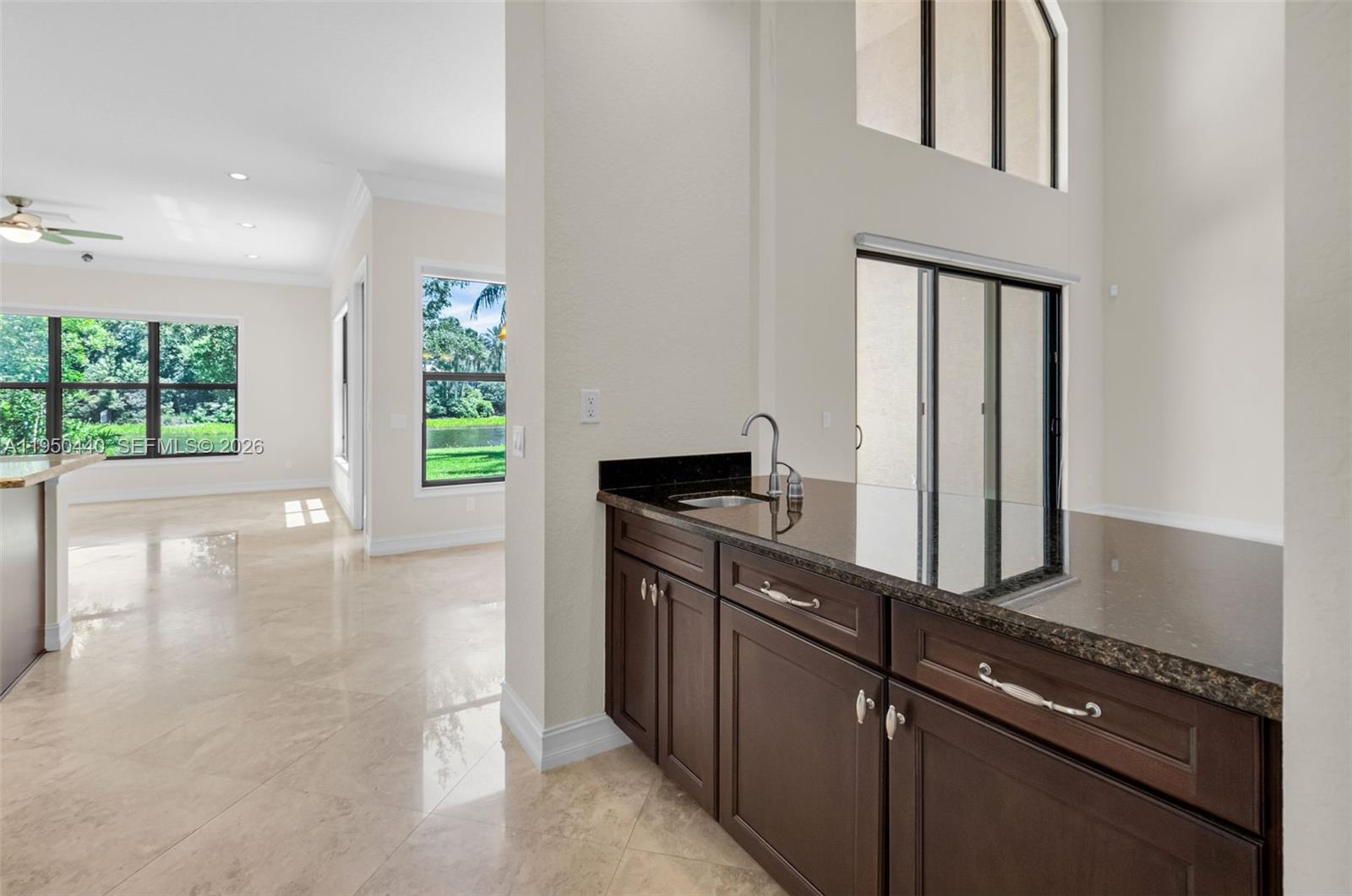8944 Little Falls Way, Unit 8944 Delray Beach, FL 33446 - Photo 12 of 98 a kitchen with granite countertop a stove and a refrigerator