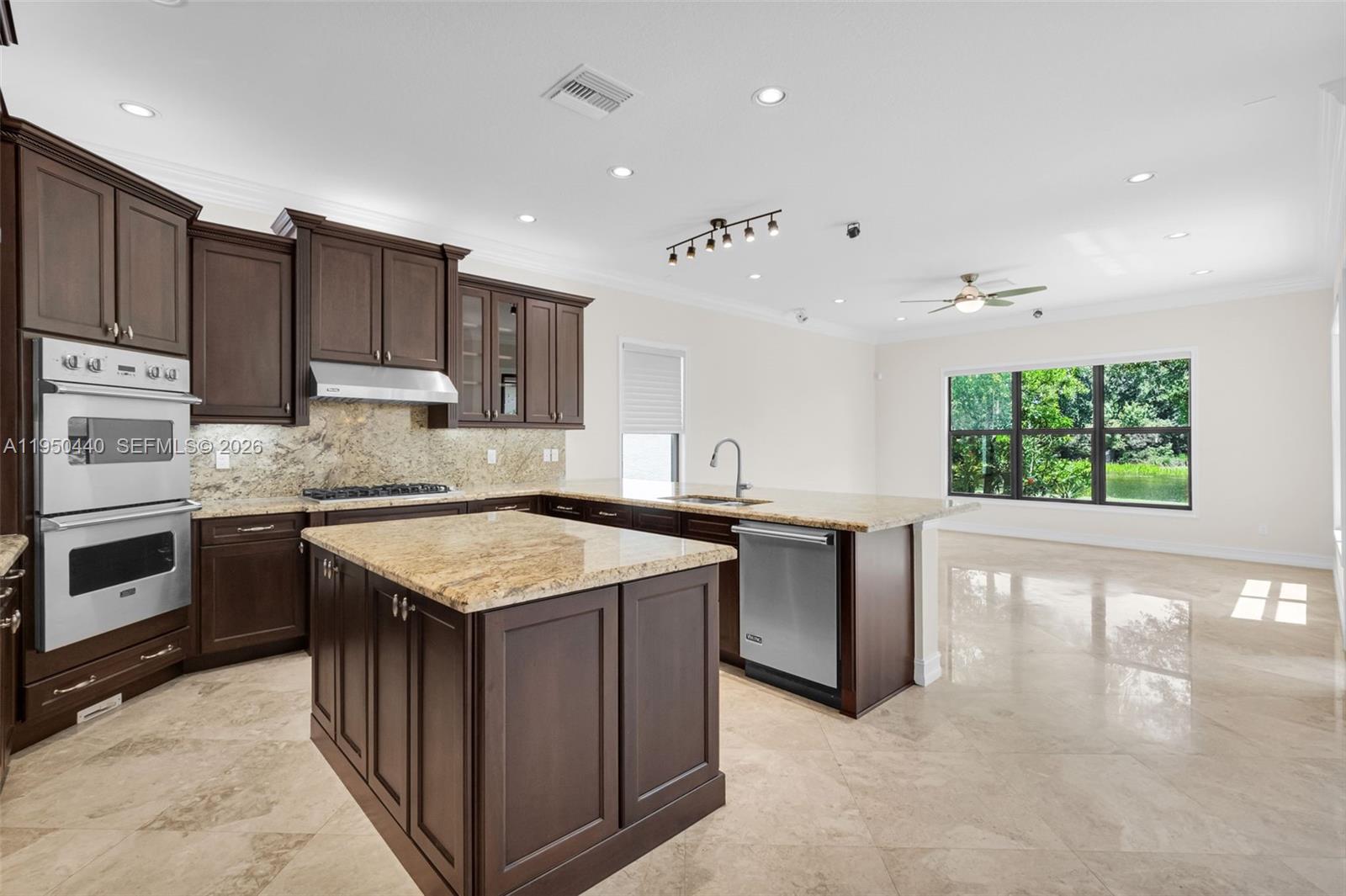 8944 Little Falls Way, Unit 8944 Delray Beach, FL 33446 - Photo 13 of 98 a kitchen with a stove sink and a microwave