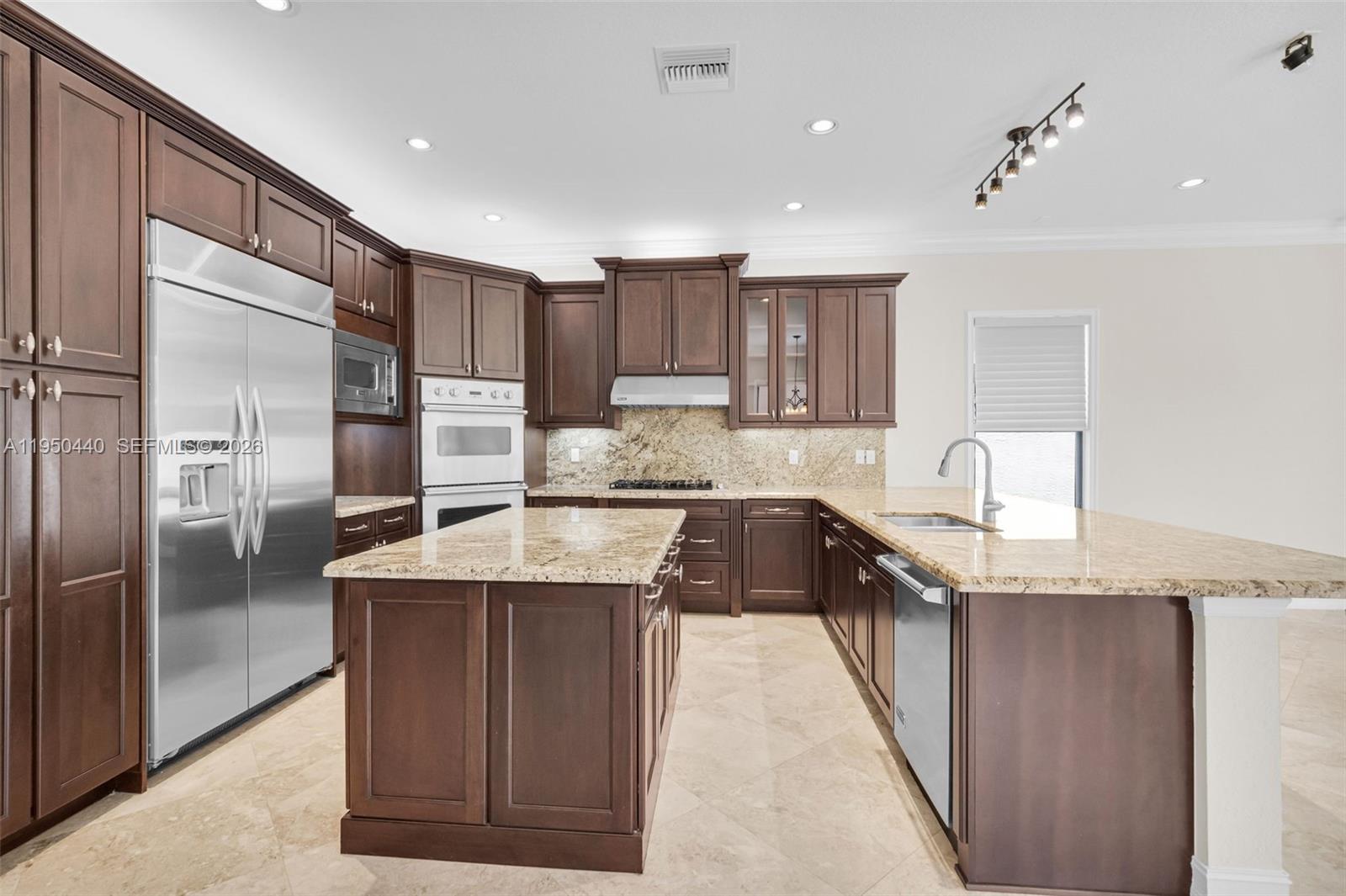 8944 Little Falls Way, Unit 8944 Delray Beach, FL 33446 - Photo 14 of 98 a kitchen with stainless steel appliances granite countertop a sink stove and refrigerator