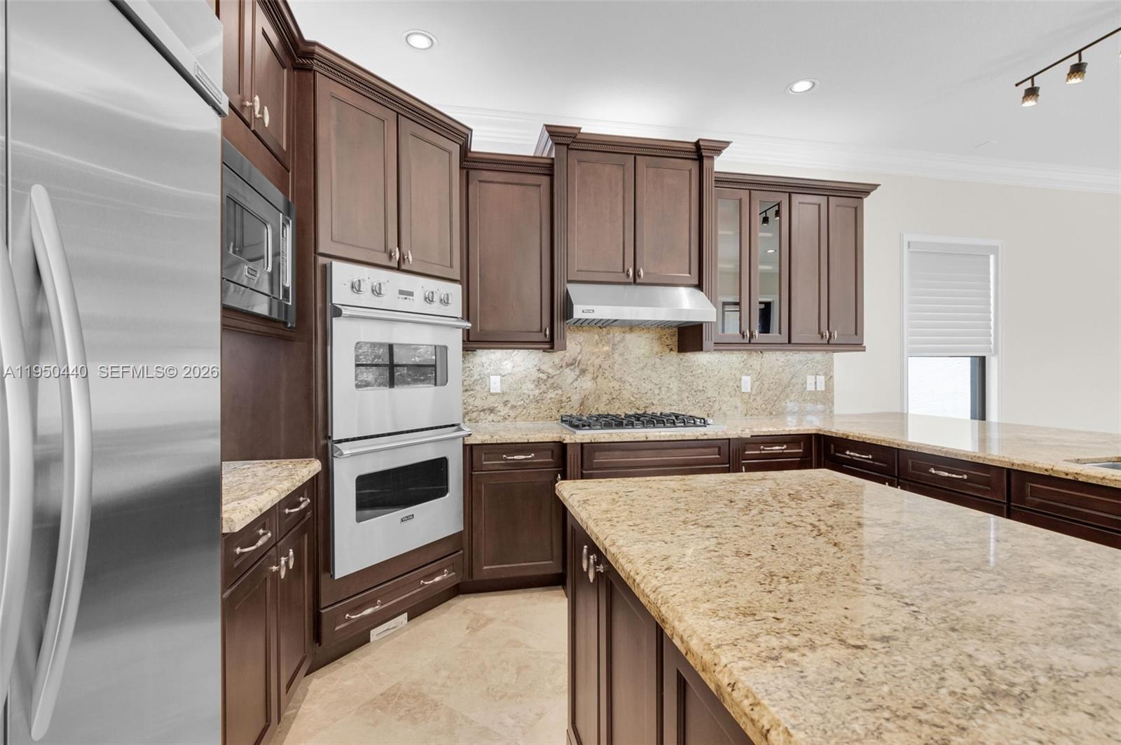 8944 Little Falls Way, Unit 8944 Delray Beach, FL 33446 - Photo 15 of 98 a kitchen with stainless steel appliances granite countertop a sink refrigerator and microwave