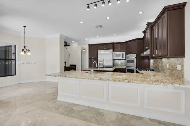 a bathroom with a granite countertop tub sink a mirror and a shower