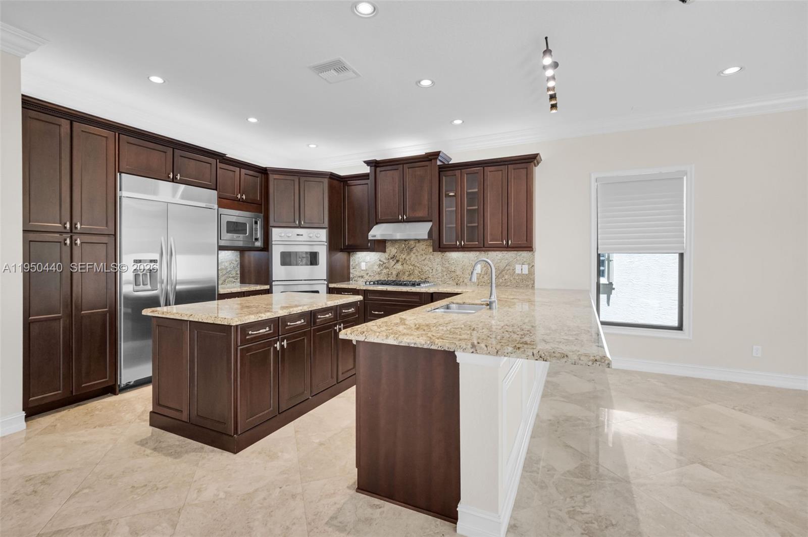 8944 Little Falls Way, Unit 8944 Delray Beach, FL 33446 - Photo 23 of 98 a kitchen with stainless steel appliances granite countertop a stove a refrigerator and a sink