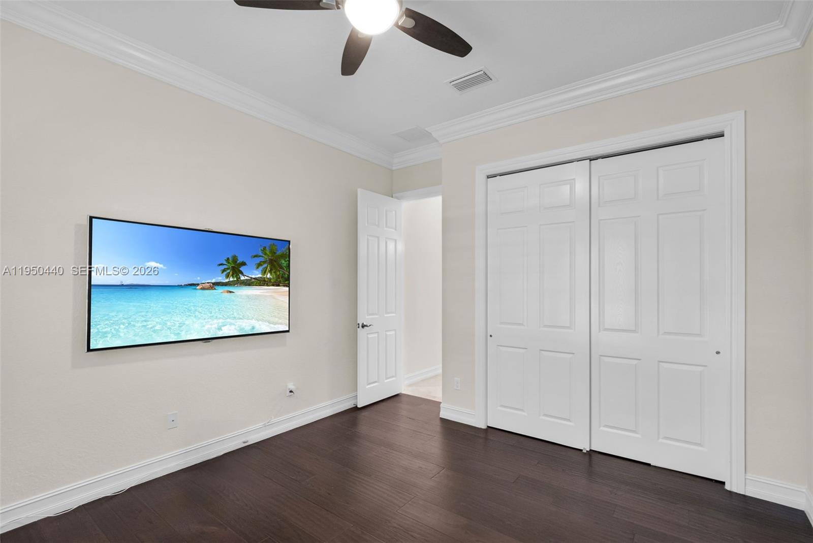 8944 Little Falls Way, Unit 8944 Delray Beach, FL 33446 - Photo 26 of 98 an empty room with wooden floor ceiling fan and windows