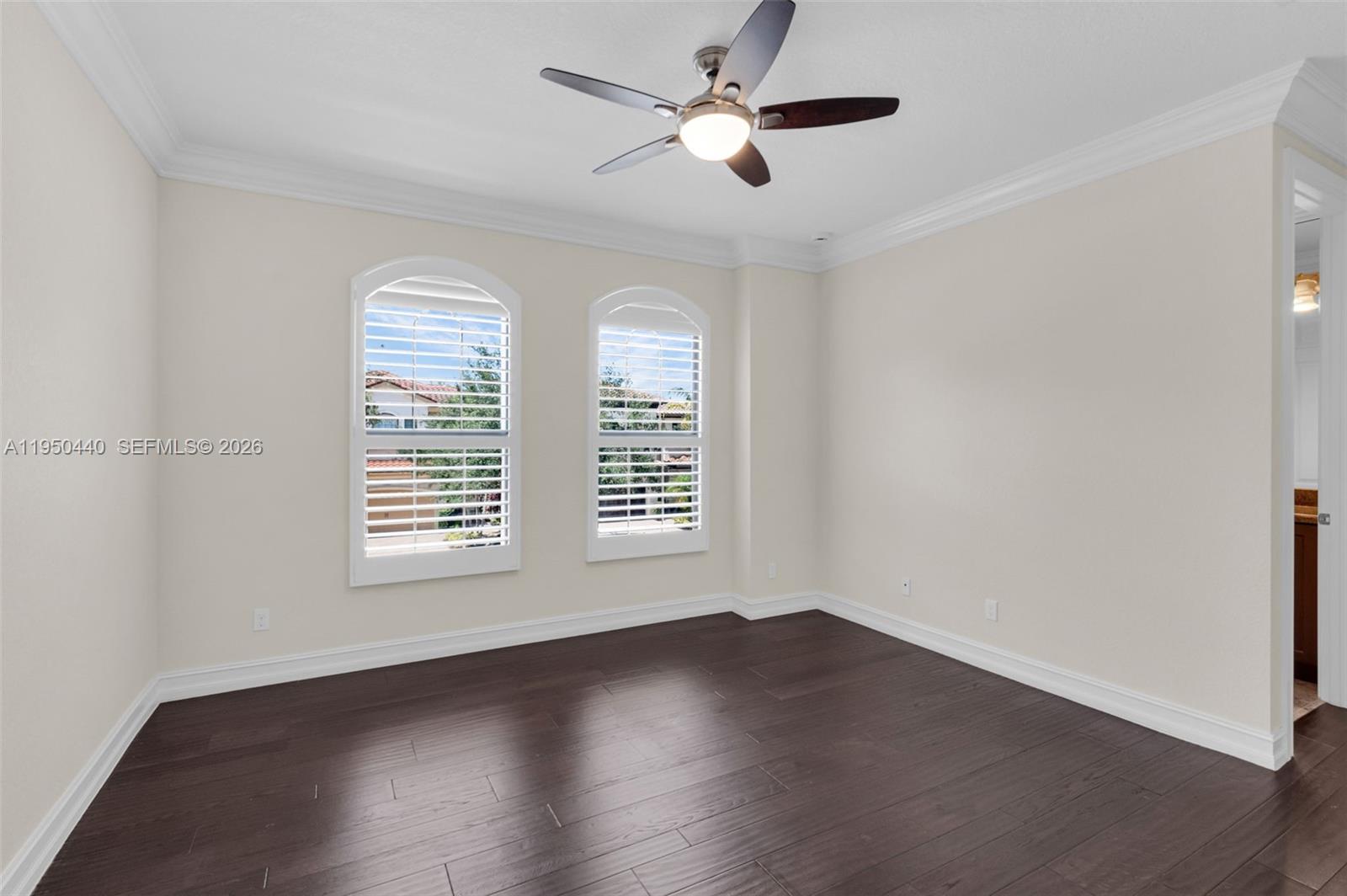 8944 Little Falls Way, Unit 8944 Delray Beach, FL 33446 - Photo 27 of 98 a view of an empty room with wooden floor and a window