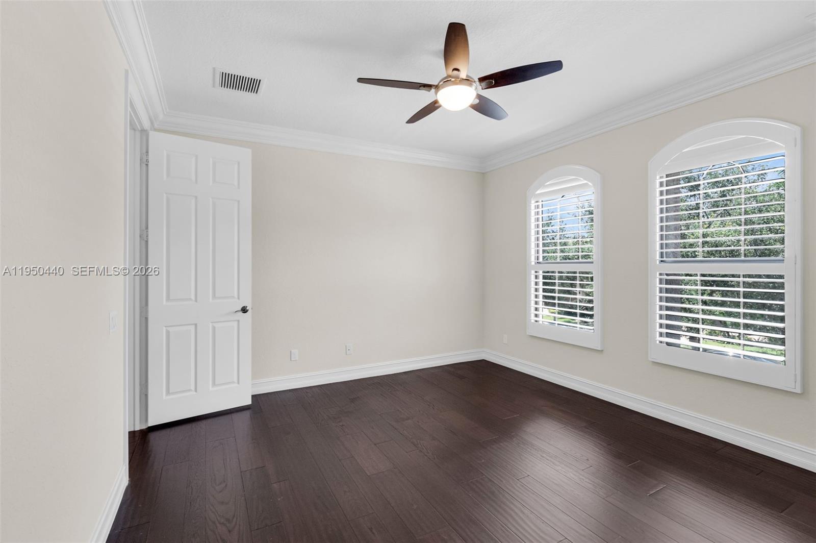 8944 Little Falls Way, Unit 8944 Delray Beach, FL 33446 - Photo 28 of 98 a view of an empty room with wooden floor and a window
