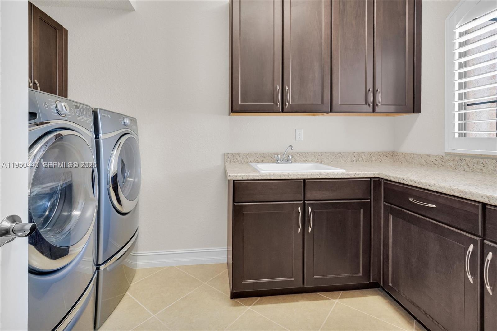 8944 Little Falls Way, Unit 8944 Delray Beach, FL 33446 - Photo 30 of 98 a kitchen with a sink and cabinets