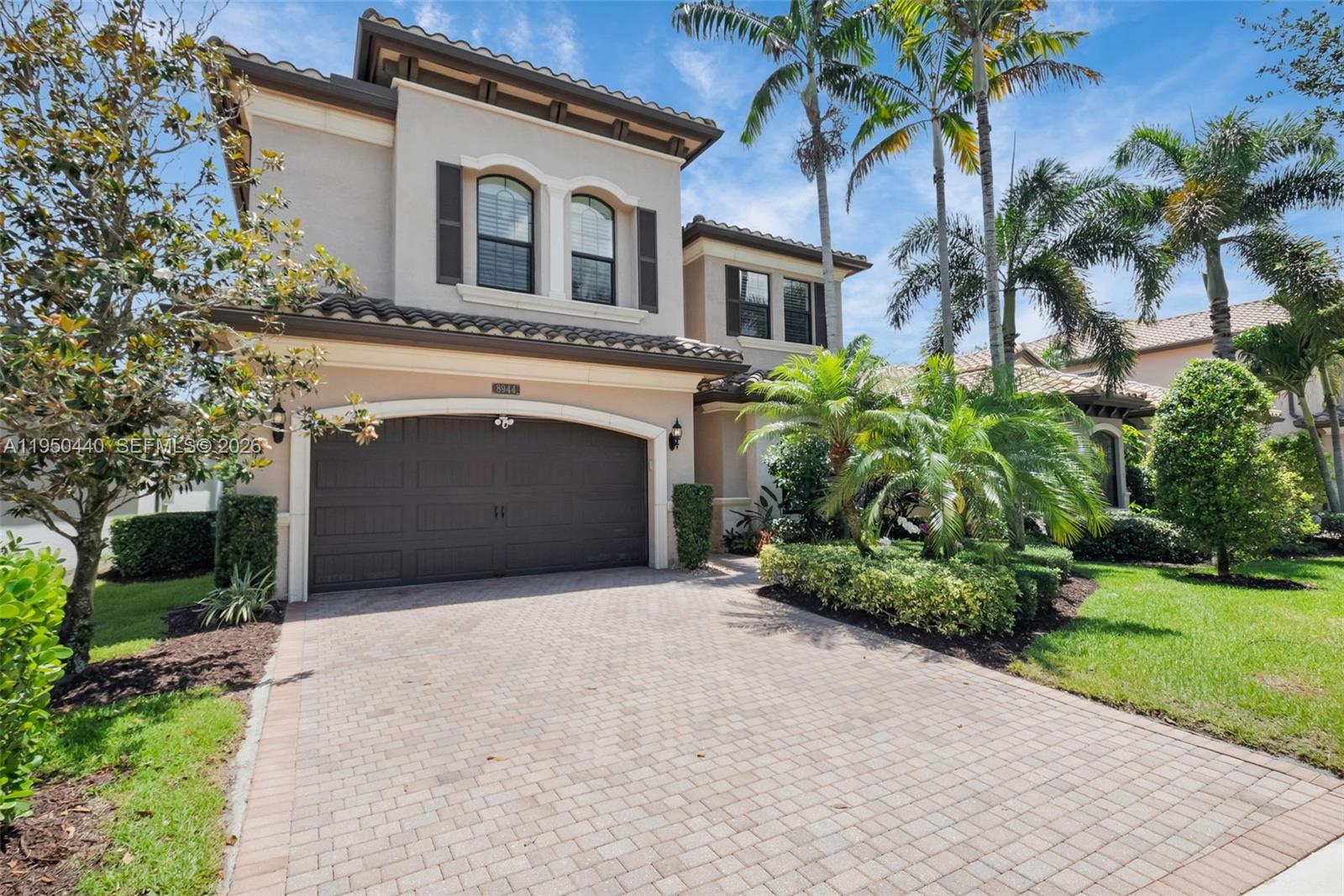8944 Little Falls Way, Unit 8944 Delray Beach, FL 33446 - Photo 3 of 98 a front view of a house with a yard and garage