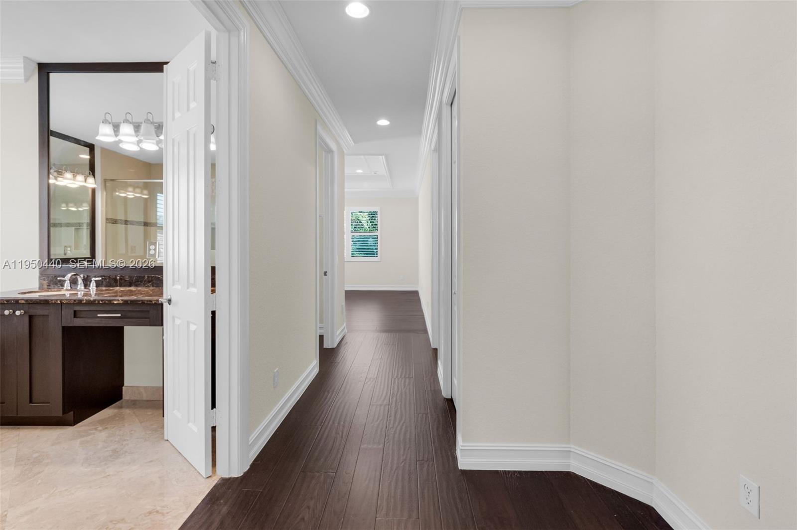 8944 Little Falls Way, Unit 8944 Delray Beach, FL 33446 - Photo 37 of 98 a view of a hallway with wooden floor and a bathroom