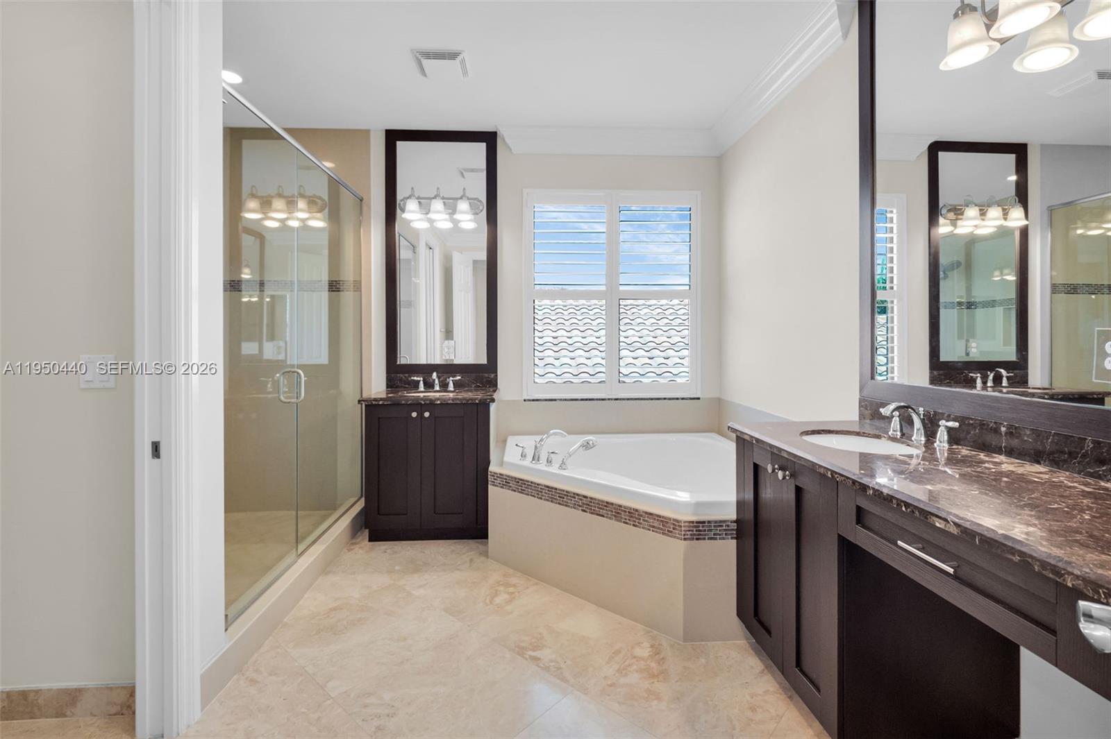 8944 Little Falls Way, Unit 8944 Delray Beach, FL 33446 - Photo 38 of 98 a bathroom with a granite countertop tub sink a mirror and a shower